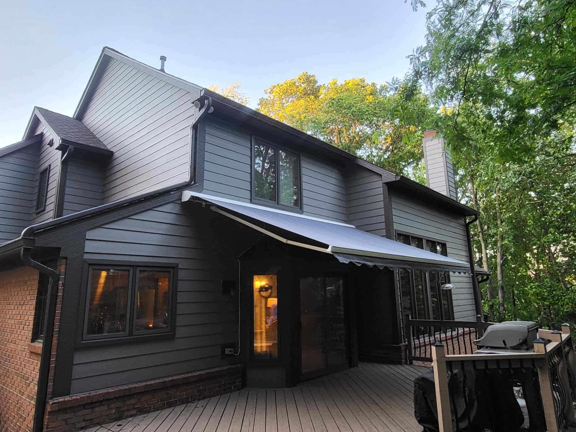 Retractable awning protecting back beck of residential home