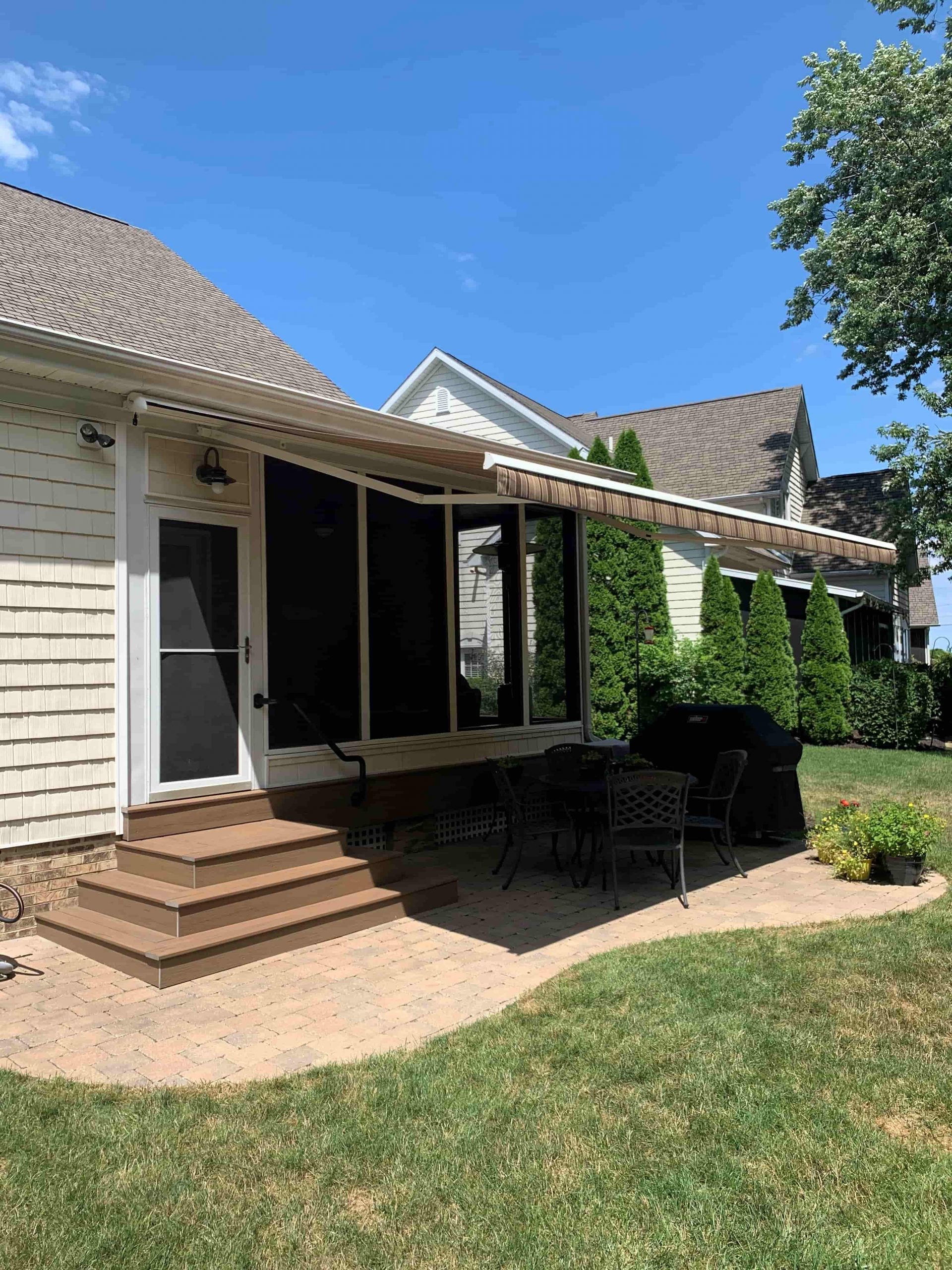 Awning protecting backyard patio area from harsh sun