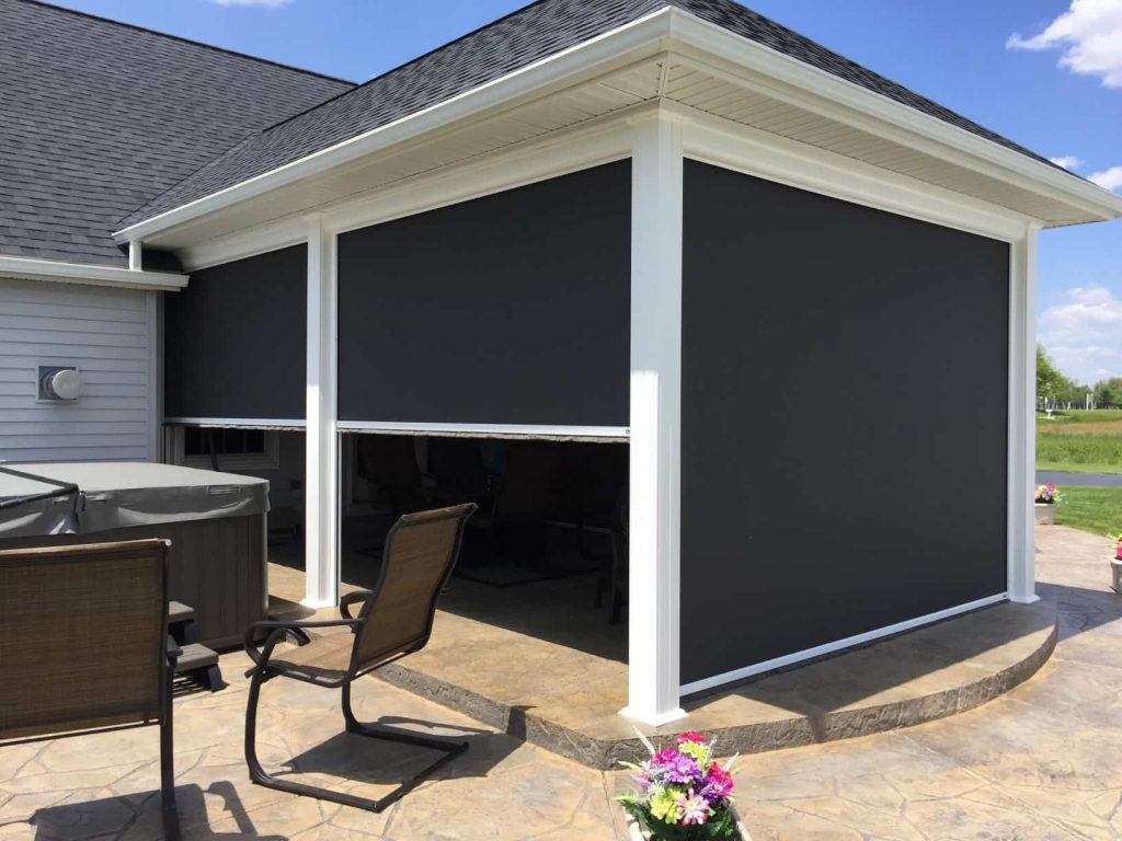 Sun shade being deployed on outdoor patio to provide complete protection